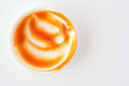 Tomato ketchup in ceramic bowl on white background.の写真素材