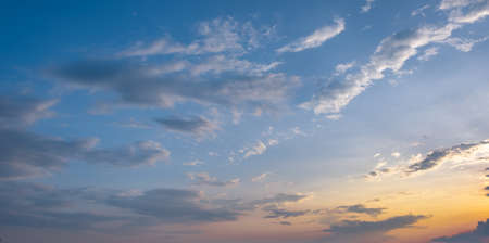 Colorful sunset and sunrise with clouds.Blue and orange color of nature.Many white clouds in the blue sky.The weather is clear today.sunset in the clouds.The sky is twilightの写真素材