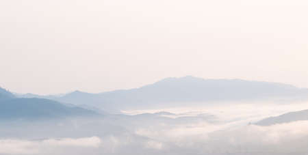 Surreal landscape of morning foggy..Morning clouds at sunrise.Landscape of fog and mountains of northern Thailandの写真素材
