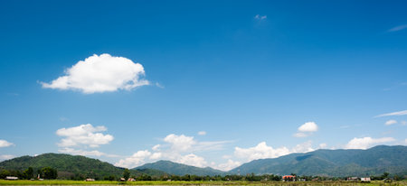The white clouds have a strange shape and country side.Cloudy and blue skyの写真素材