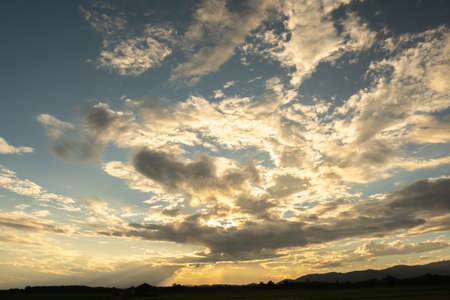 Colorful sunset and sunrise with clouds.Orange color of nature.Many white clouds in the sky.The weather is clear today.sunset in the clouds.The sky is twilightの写真素材