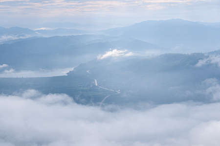 Surreal landscape of morning foggy..Morning clouds at sunrise.Landscape of fog and mountains of northern Thailandの写真素材