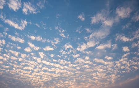 White cloudy with a blue  sky.Wave clouds on the sky.Fluffy cloud and sunsetの写真素材