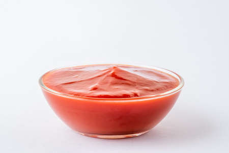Tomato ketchup in glass bowl on white background.の写真素材
