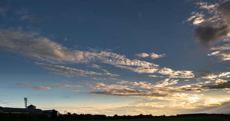 Colorful sunset and sunrise with clouds.Orange color of nature.Many white clouds in the sky.The weather is clear today.sunset in the clouds.The sky is twilightの写真素材