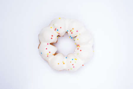 White donut with topping on white backgroundの写真素材