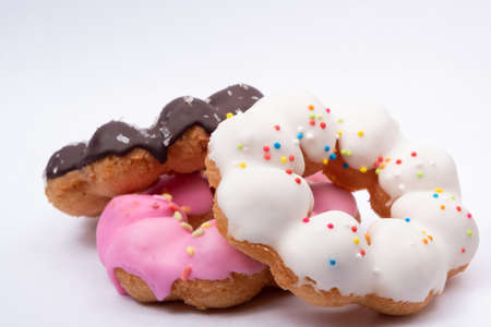 Three kinds of donuts have chocolate, white cream, pink cream on white backgroundの写真素材