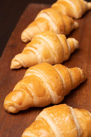 Fresh croissants on a wooden board. Fresh bakery croissants.selective focusの写真素材