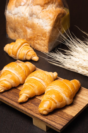 Fresh croissants on a wooden board. Fresh bakery croissants.selective focusの写真素材