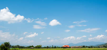 The white clouds have a strange shape and country side.Cloudy and blue skyの写真素材