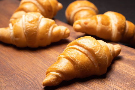 Fresh croissants on a wooden board. Fresh bakery croissants.selective focusの写真素材