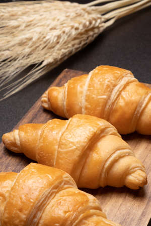 Fresh croissants on a wooden board. selective focus .bakery with copy spaceの写真素材