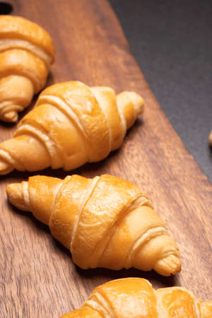 Fresh croissants on a wooden board. Fresh bakery croissants.selective focusの写真素材