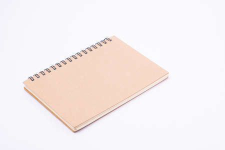 Brown notebook on white background.The cover is made of cardboard, covered with recycled paper, which is durable and environmentally friendly.Suitable for writing or taking notesの写真素材