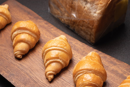 Fresh croissants on a wooden board. Fresh bakery croissants.selective focusの写真素材
