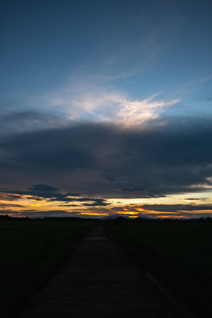 Colorful sunset and sunrise with clouds.Blue and orange color of nature.Many white clouds in the blue sky.The weather is clear today.sunset in the clouds.The sky is twilightの写真素材