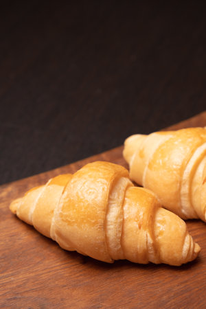 Fresh croissants on a wooden board. selective focus .bakery with copy spaceの写真素材