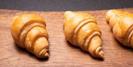 Fresh croissants on a wooden board. Fresh bakery croissants.selective focusの写真素材