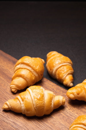 Fresh croissants on a wooden board. selective focus .bakery with copy spaceの写真素材
