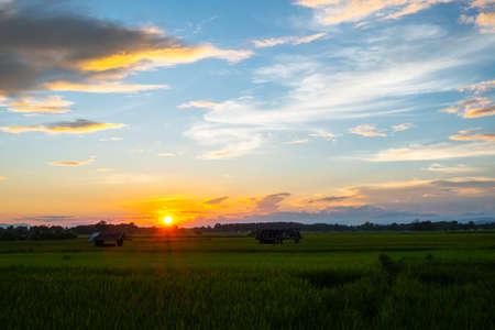Colorful sunset and sunrise with clouds. Blue and orange color of nature. Many white clouds in the blue sky. The weather is clear today. sunset in the clouds. The sky is twilightの写真素材