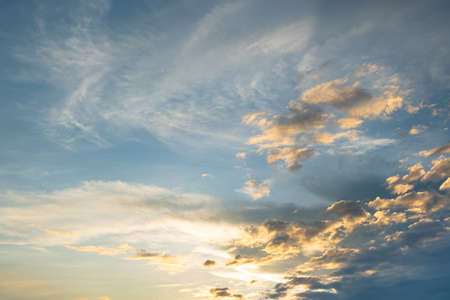 Colorful sunset and sunrise with clouds. Blue and orange color of nature. Many white clouds in the blue sky. The weather is clear today. sunset in the clouds. The sky is twilightの写真素材