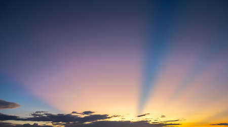 Colorful sunset and sunrise with clouds.Blue and orange color of nature.Many white clouds in the blue sky.The weather is clear today.sunset in the clouds.The sky is twilightの写真素材