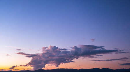 Colorful sunset and sunrise with clouds.Blue and orange color of nature.Many white clouds in the blue sky.The weather is clear today.sunset in the clouds.The sky is twilightの写真素材