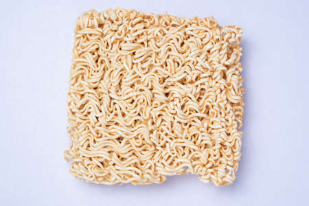 Uncooked instant noodles on white backgroundの写真素材