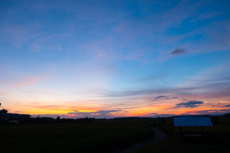 Colorful sunset and sunrise with clouds. Blue and orange color of nature. Many white clouds in the blue sky. The weather is clear today. sunset in the clouds. The sky is twilightの写真素材