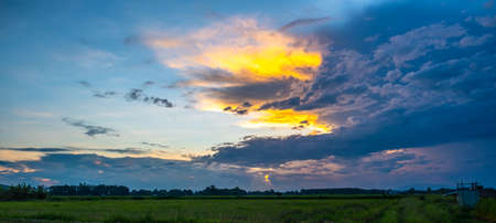 Colorful sunset and sunrise with clouds. Blue and orange color of nature. Many white clouds in the blue sky. The weather is clear today. sunset in the clouds. The sky is twilightの写真素材