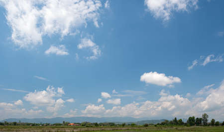 The white clouds have a strange shape and country side.Cloudy and blue skyの写真素材