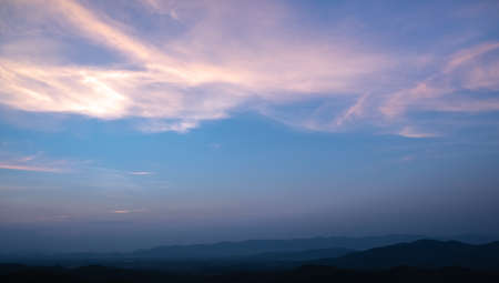 Colorful sunset and sunrise with clouds. Blue and orange color of nature. Many white clouds in the blue sky. The weather is clear today. sunset in the clouds. The sky is twilightの写真素材