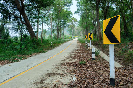 Thailand country road landscape.Traveler journey by roads.the scenery of the country road and the mountains on both sides of the road with treesの写真素材