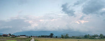 Storm clouds are forming over the top of the mountain.clouds moving over mountain peaksの写真素材