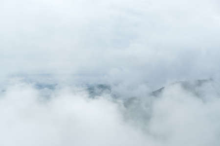 Surreal landscape of morning foggy.Morning clouds at sunrise.Landscape of fog and mountains of northern Thailand.morning fog clouds on the mountainの写真素材