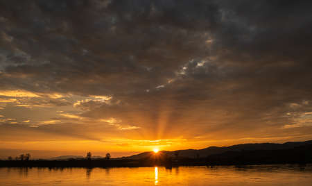Colorful sunset and sunrise with clouds. Blue and orange color of nature. Many white clouds in the blue sky. The weather is clear today. sunset in the clouds. The sky is twilightの写真素材