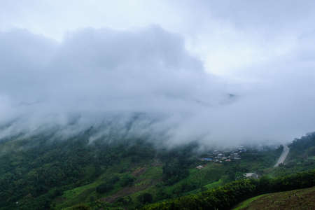 Surreal landscape of morning foggy.Morning clouds at sunrise.Landscape of fog and mountains of northern Thailand.morning fog clouds on the mountainの写真素材
