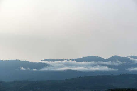 Surreal landscape of morning foggy.Morning clouds at sunrise.Landscape of fog and mountains of northern Thailand.morning fog clouds on the mountainの写真素材