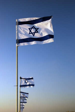 Israeli flag against the blue sky in the sunの写真素材