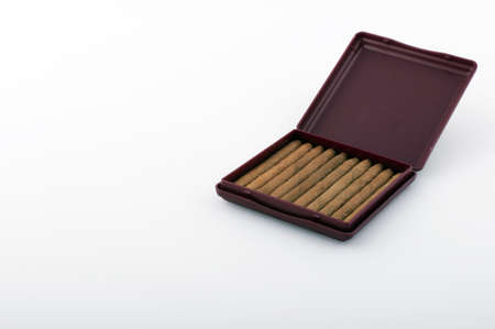 Brown cigar tobacco on a white backgroundの写真素材