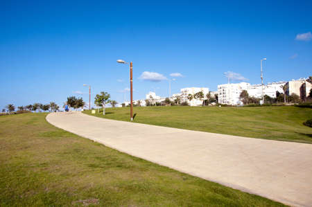Footpaths in the park against the backdrop of the cityの写真素材