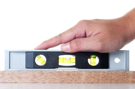 A hand measure the balance with measurement tools on wood isolate with white background.の写真素材