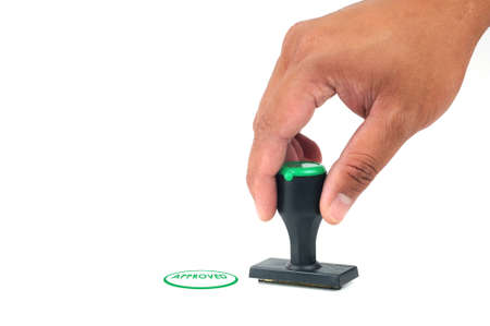 Hand hold approved Stamp in Green Color isolated white backgroundの写真素材