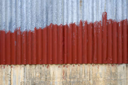 rust old zink painted with red. The zink overlap concerete wallの写真素材