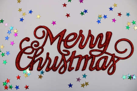 Christmas greeting in red on white background with beautiful starsの写真素材