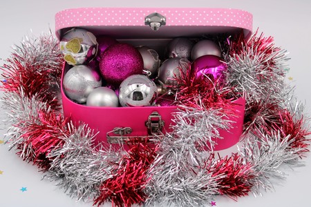 Pink box full of Christmas ornaments in silver and purpleの写真素材