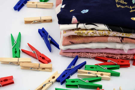 Folded clothes and plastic and wooden clothespins
