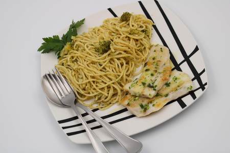 Spaghetti dish with broccoli sauce and grilled fishの写真素材