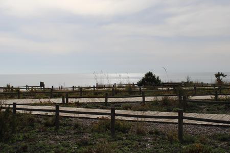 Boardwalk with wooden paths on the beach and benches to sit in Retamar AlmerÃ­aの写真素材
