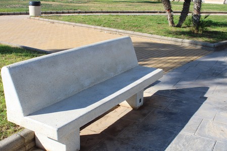White stone bench and green space in recreational parkの写真素材